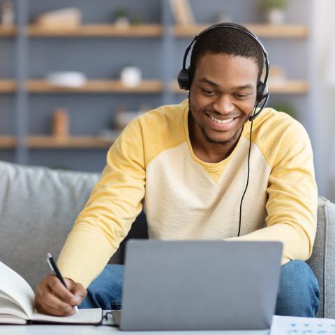 African American yoiung male studying on his lasptop at home