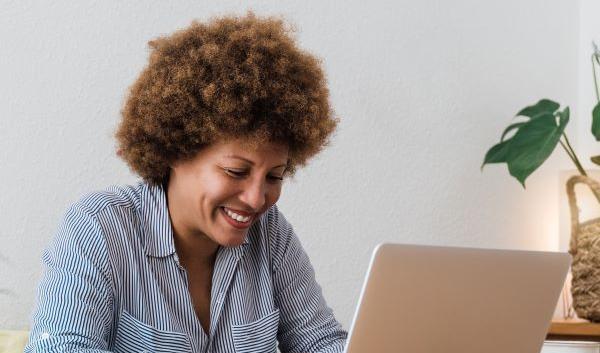 happy-african-mature-woman-using-laptop-computer
